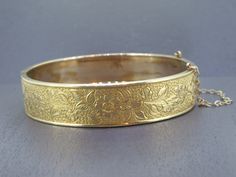 Gorgeous antique bangle bracelet. Signed gold filled.  Light wear to the finish on the outside, heavier wear to the finish on the inside of the bracelet.  Box clasp works great and has a safety chain.  Signed as you can see in the pictures.    Visit Ribbons Edge for more great pieces of vintage and antique jewelry!  All items added to your cart at Ribbons Edge will automatically combine shipping. To stay up to date with my newest offerings, follow me on IG @ RibbonsEdge Luxury Antique Gold Bracelet Engraved, Antique 14k Stamped Bangle As Gift, Vintage 14k Stamped Gold Bangle, Victorian Gold Bracelets For Wedding, Victorian Style Gold Bracelets For Wedding, Victorian Gold Bangle Cuff Bracelet, Antique Etched Gold Bracelets, Antique Etched Gold Bracelet, Heirloom Gold Hinged Bracelets