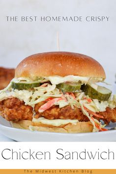 the best homemade crispy chicken sandwich is on a plate with coleslaw and pickles