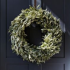 a wreath is hanging on the front door