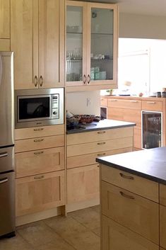 a kitchen with stainless steel appliances and wooden cabinets