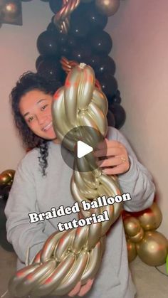 a woman is holding up some balloons in front of her face and the caption reads braided balloon tutorial