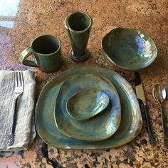 a table set up with dishes and utensils