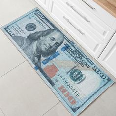 a kitchen area rug with a dollar bill on the floor next to a counter top