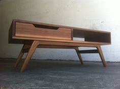 a wooden desk with two drawers on the bottom and one drawer open to reveal something