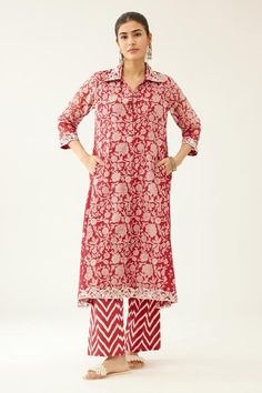 Red A-line short kurta with bouquet hand block print and sequin, tassel, bead embroidery on collar and sleeve hem. Paired with chevron hand block printed straight pant. Components: 2 Pattern: Hand Block Printed, Embroidery Type Of Work: Bouquet, chevron, sequin, tassel, bead Neckline: Shirt collar Sleeve Type: Three quarter Fabric: Kurta: Silk Chanderi, Pant: Cotton Color: Red Other Details:  Lined kurta Embroidered neckline and sleeve hem Elasticated waist at the back Side pockets Occasion: Meh Bell Bottom Trouser, Collar Kurti, Red And White Shirt, Block Printed Suits, Red Kurta, Printed Embroidery, Short Kurta, Red Bouquet