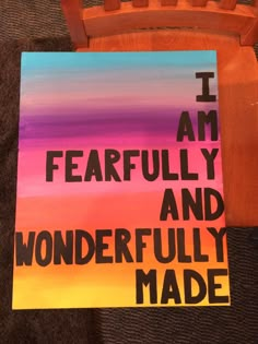 a piece of art that says i am fearless and wonderfully made on the back of a wooden chair