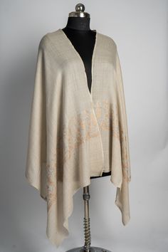 This warm beige merino wool scarf, adorned with hand-embroidered sozni work, evokes the beauty of the desert landscape. The soft hues of the intricate embroidery, crafted in earthy tones, add a subtle sophistication that speaks of timeless craftsmanship. A versatile accessory for any season, this scarf offers the perfect blend of warmth and style. Its soft texture and exquisite embroidery make it an essential piece for anyone who values luxury and artisanal quality. Luxury Elegant Embroidered Scarf, Luxury Beige Pashmina Shawl With Embroidered Border, Embroidered Rug, Scarf Jacket, Embroidered Handbag, Merino Wool Scarf, Silk Carpet, Warm Beige, Desert Landscape