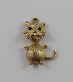 "This is a vintage \"Cat With Green Stone Eyes\" 10 karat gold charm for a charm bracelet.  It weighs 4.00 grams and measures 3/4\" x 1 1/8\", marked \"10K\" All charms come with a split ring to attach to a bracelet. We have hundreds of charms in stock. If you don't see what you are looking for in our shop please contact us as it is likely we have it. Inventory #G2367" Antique Gold Charms For Collectors, Vintage Engraved Yellow Gold Charm Bracelet, Vintage 14k Gold Engraved Charms, Vintage Engraved 14k Gold Charms, Vintage Yellow Gold Charms For Gift, Vintage Gold-tone Charms For Gifts, Vintage 14k Gold Charms For Gift, Vintage Gold-tone Charm Bracelet As Gift, Vintage Yellow Gold Charms For Anniversary