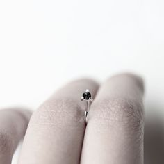 Handmade natural diamond sterling silver hug earrings. Each earring hugs the ear with a natural black diamond held with three prongs at the front. The diamond is set inverted. Diamond: 2.5mm, opaque Dimensions: 10x9mm Sold: Individually or as a pair Also available with white sapphires (last photo): https://www.etsy.com/listing/252736724/sapphire-thorn-white-sapphire-earring * Please note these earrings come with no backings as their shape secures them in place. Visit my shop: http://www.etsy.com White Sapphire Earrings, Wrap Earrings, Oxidized Sterling Silver, Silver Earring, White Sapphire, Handmade Sterling Silver, Black Diamond, Sterling Silver Earrings, Handmade Natural