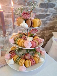 three tiered trays filled with macaroons and other pastries