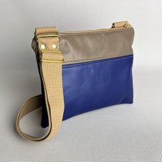 Keep your tickets, passport, and phone right at your hip and make that TSA line go just a little bit quicker. Our crossbody pouch can keep even the messiest traveler organized while staying fashionable. Using upcycled leather from Southwest Airlines, the rich blue and neutral tan leather complement each other to form the perfect bag! This bag is made from upcycled leather from Southwest Airlines seat covers which have been cleaned and refurbished prior to being handcrafted into this gorgeous sus Blue Shoulder Bag With Leather Trim For Daily Use, Blue Shoulder Bag With Leather Trim For Everyday, Everyday Blue Shoulder Bag With Leather Trim, Blue Leather Shoulder Bag With Zipper Pocket, Blue Leather Shoulder Bag With Leather Trim, Functional Blue Leather Shoulder Bag, Navy Leather Shoulder Bag For On-the-go, Airline Seats, Upcycled Leather