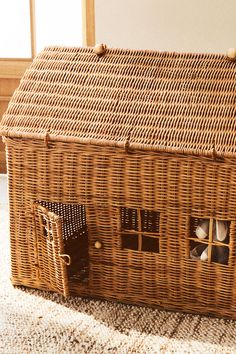 a house made out of wicker sitting on the floor