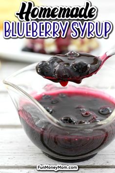 homemade blueberry syrup in a glass bowl with a spoon full of it and the text overlay reads homemade blueberry syrup