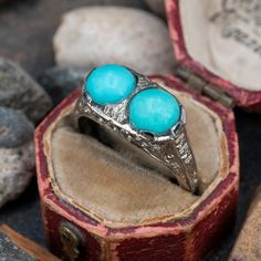 This fascinating twin turquoise cabochon ring is crafted of 18k white gold. This ring is currently a size 7.5. The turquoise show visible epoxy around the stones to help keep them secure. Luxury Turquoise Ring With Prong Setting, Luxury Polished Turquoise Ring, Luxury Hallmarked Turquoise Ring For Wedding, Luxury Blue Turquoise Ring With Center Stone, Luxury Classic Turquoise Rings, Luxury Classic Blue Turquoise Ring, Luxury Turquoise Ring With Center Stone, Luxury Handmade Turquoise Ring, Luxury Heirloom Turquoise Ring Hallmarked