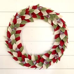 a red and white wreath hanging on the wall