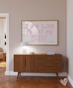 a wooden sideboard with a pink sign above it