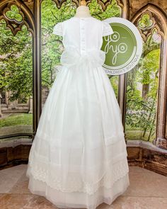 An adorable and romantic, yet classical communion gown for girls made with a lightweight optic white organza and embroidered laces. It has delicate pleats throughout and lace details on the sleeves, skirt, and body of the dress. This dress has buttons and a bow on the back for closure. True to size Lining: 100% cotton Dry clean Made in Spain Final Sale, no exchanges nor returns are available Size chart is in centimeters Claudia Dress, First Communion Dress, Spanish Fashion, Gowns For Girls, Communion Dresses, Children's Boutique, Dresses For Girls, Dress 16, First Communion