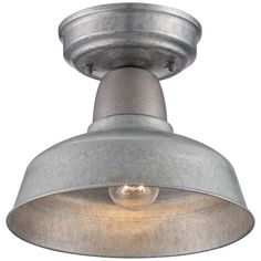 a light that is on top of a ceiling fixture with a metal shade over it