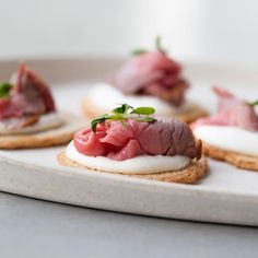 small appetizers with meat and cream cheese on crackers