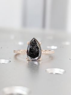 a black diamond ring sitting on top of a table