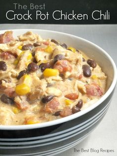 the best crock pot chicken chili is in a white bowl with black beans and corn