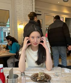 a woman sitting at a table with food in front of her