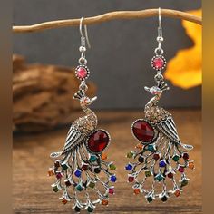 New Red Silver Peacock Chandelier Dangle Earrings A Gorgeous Pair Of Earrings With Multicolored Stones In A Silver Tone Setting Eye-Catching Design That Will Turn Heads Made Of High-Quality Materials Great For Gift Giving New A6034-35 Other Listings J.Crew Abercrombie And Fitch Nike Levi's Columbia Lee Victoria's Secret Wrangler Talbots Skechers Adidas Chico's Fila Vince Camuto Old Navy Athleta Eddie Bauer Madewell Ralph Lauren Polo Ann Taylor Loft Disney Free People Tailorbyrd Puma Gloria Vande Party Earrings In Peacock Color, Multicolor Peacock Design Earrings For Party, Red Peacock Design Earrings For Gifts, Elegant Red Jewelry With Peacock Design, Peacock Design Dangle Chandelier Earrings Gift, Elegant Red Peacock Design Earrings, Festive Red Peacock Earrings, Peacock Design Dangle Chandelier Earrings, Red Nickel-free Chandelier Drop Earrings