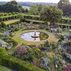 an aerial view of a formal garden and fountain