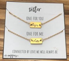 two gold necklaces that say sister one for you, one for me and one for me