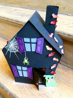 a paper house with bats and spider webs on it