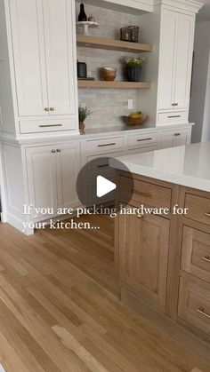 a kitchen with white cabinets and wood floors is shown in the video titled if you are picking hardware for your kitchen