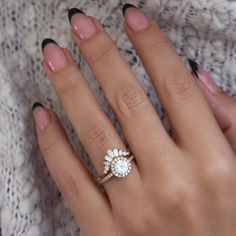 a woman's hand with a ring on it