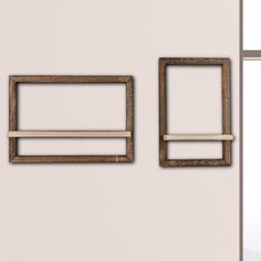 there are two wooden frames on the wall next to each other, one is empty