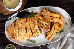 a white plate topped with french fries next to a bowl of gravy