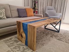 a living room with a couch, chair and table made out of wooden planks