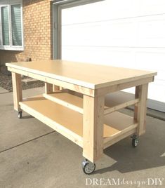 a wooden table sitting on top of a sidewalk next to a garage door and brick building