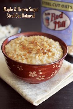 a bowl of food sitting on top of a table next to a bottle of milk