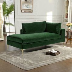 a green couch sitting on top of a rug in a living room