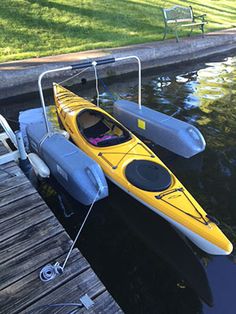 a yellow kayak is tied to the dock