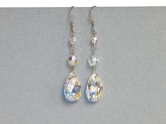 Bold Swarovski crystal bridal earrings. Rock your wedding day with crystals. Wanting more bridal bling?? These earrings are what you need!! AB Swarovski crystal teardrops and round crystals. Watch them sparkle in the sunlight.  Bridal jewelry and bridesmaid gifts by Celebrating Together.  #bridalearrings #bridalfashion #weddingearrings #crystalearrings #weddingjewelry Crystal Dangle Earrings