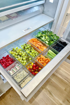 an open refrigerator filled with lots of different types of fruits and vegtables