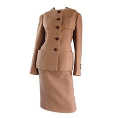 Such a classic skirt and jacket suit set by NORMAN NORELL! This chic 60s ensemble is the perfect camel color, that will get you through all the months of the year. Haute Couture quality, with an amazing wool fabric! Chic brown buttons up the bodice of the jacket, with functional pockets at both breasts, and at both sides of the waist. High waisted pencil skirt, with flattering darts, and metal zipper, and button at waistband. Both pieces work fantastic together, or as separates! Fully lined. App Norman Norell, 60s Skirt, 60s Women, Classic Skirts, Fashion Family, Fashion 1950s, Vintage Suits, Blazer And Skirt, High Waisted Pencil Skirt