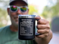 a man holding up a blue coffee mug with an oncolidist nutrition label