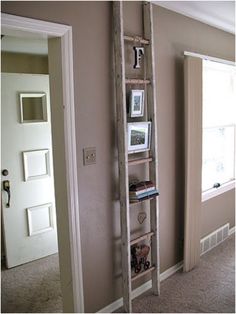 a ladder leaning up against the wall in a room with carpeted flooring and beige walls