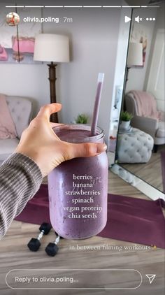 a person holding a purple smoothie in front of a mirror with the caption be nice to your self