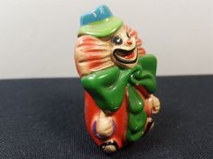 a small ceramic figurine of a clown