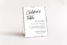 a white sign with black writing on it that says children's table