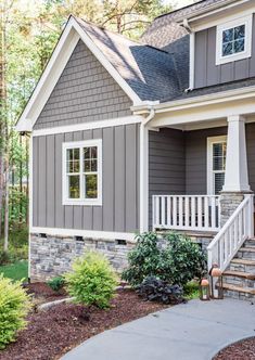 a house with gray siding and white trim