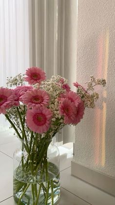 a vase filled with pink and white flowers