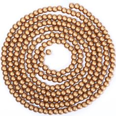 a strand of gold beads on a white background